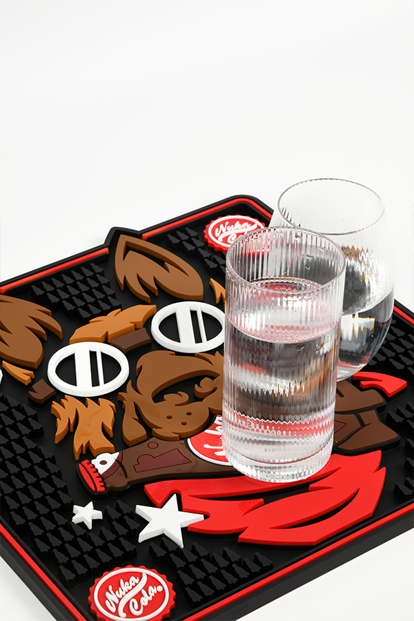 Rubber mat with cartoon bear design and glasses of water on a white background