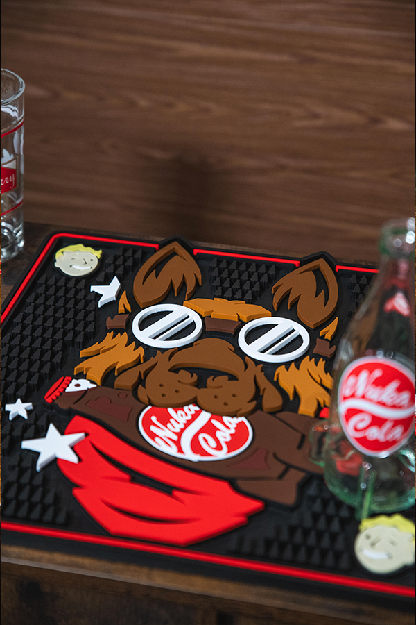 Decorative mat with a bear design and Coca-Cola logo on a wooden surface.