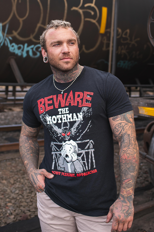 Man wearing a black t-shirt with 'Beware the Mothman' graphic design.