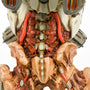Close-up shot of the DOOM Eternal Revenant Statue, showing the details of the demon’s lower back and pelvis. The vertebrae and the red flesh of the back are exposed. Red wires from the cybernetics run along the back and connect the pelvis to the thighs.