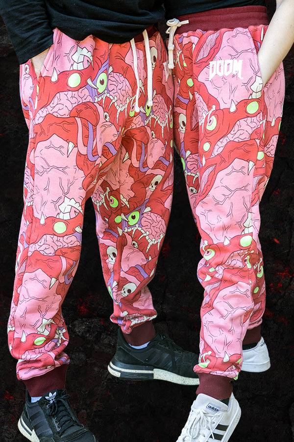 Quarter view of 2 pairs of DOOM Meat Sweats worn by a man and a woman.