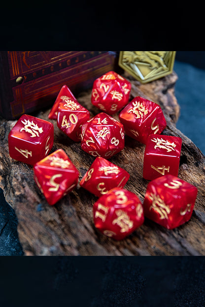 The set’s 11 polyhedral dice, showing the details of their pearlescent red resin, gold-colored numbers, and the dragon head symbol in the place of each die’s highest digit.