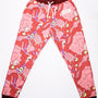 Overhead shot of the DOOM Meat Sweats, a pair of comfy unisex sweatpants with a tapered jogger fit. They feature an all-over print of scrambled demon meat and bones (eyes, teeth, brains, intestines, skulls, and muscles), ribbed burgundy cuffs and waistband, and a white DOOM logo appliqué on the wearer’s left hip.