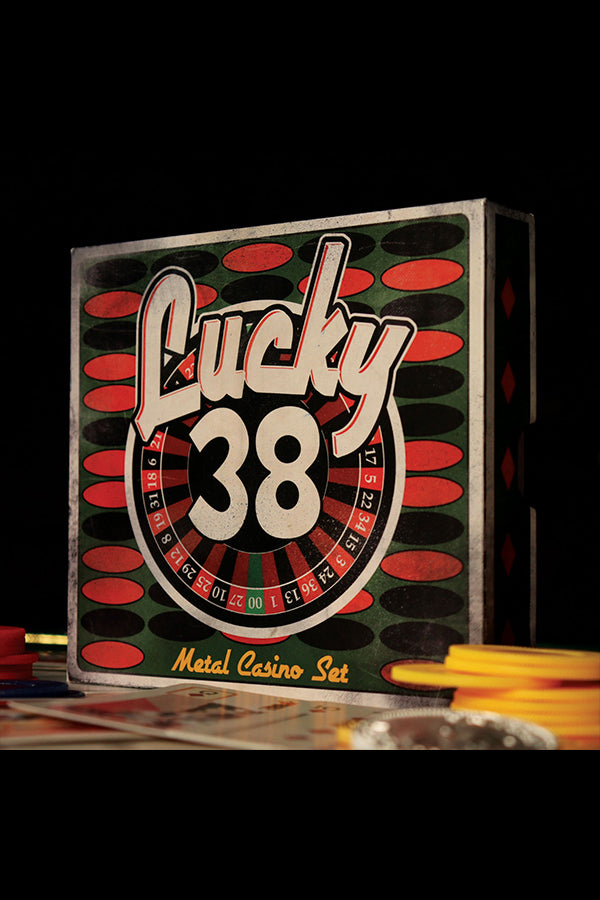 Angled shot of the back of the Lucky 38 metal Ace of Spades among playing cards and chips.