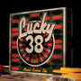 Angled shot of the back of the Lucky 38 metal Ace of Spades among playing cards and chips.