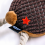 Detail shot of the Fallout NCR Bear Pet Chew Toy feat. a round tail and the embroidered red New California Republic star on its backside.