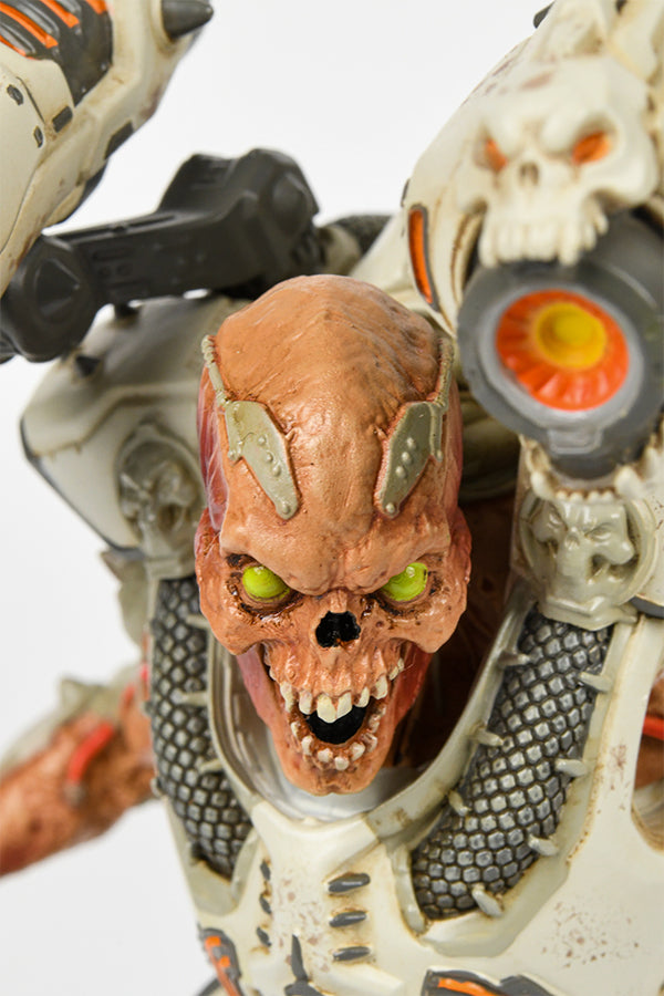Close-up shot of the DOOM Eternal Revenant Statue, showing the details of its head—a skull with sparse muscles and bright yellow eyes.