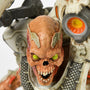 Close-up shot of the DOOM Eternal Revenant Statue, showing the details of its head—a skull with sparse muscles and bright yellow eyes.